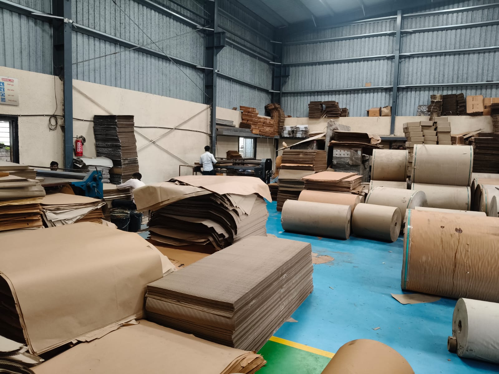 Raw paper rolls stacked in warehouse