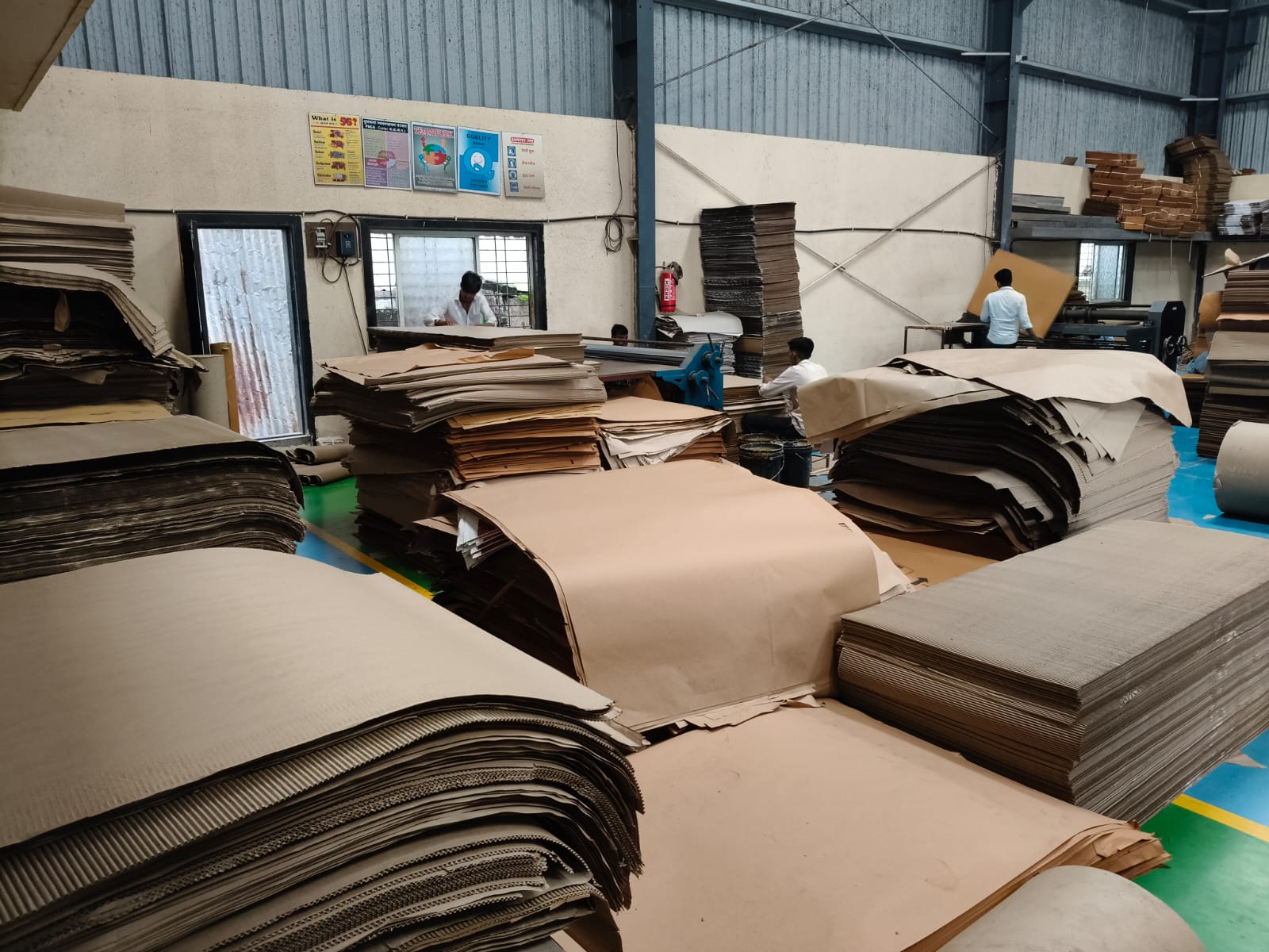 Workers processing corrugated sheets